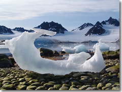 An eroded iceberg on a pebble beach on Spitsbergen, Svalbard, Norway.