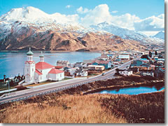 The red and green roof of a Russian-Orthodox-style church brings a spot of color to the mountainous winter landscape on Alaska's Marine Highway.